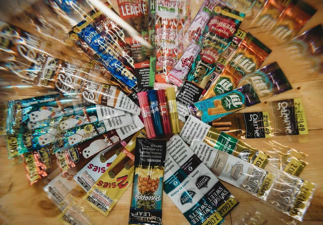 Colorful snack packages arranged in a radial display on a wooden surface