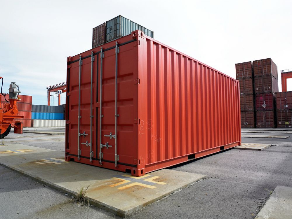 Red Shipping Container in a Port Yard With Stacked Containers — All Sunshine Coast Towing In Maroochydore, QLD