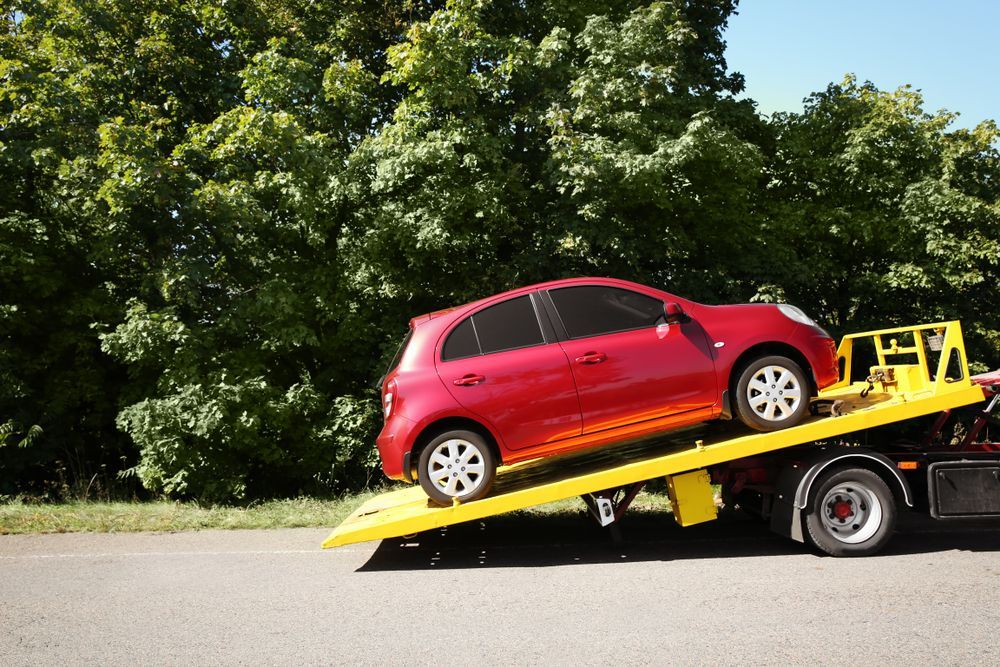 Red Hatchback Car Loaded on a Tilted Tow Truck — All Sunshine Coast Towing In Coolum, QLD