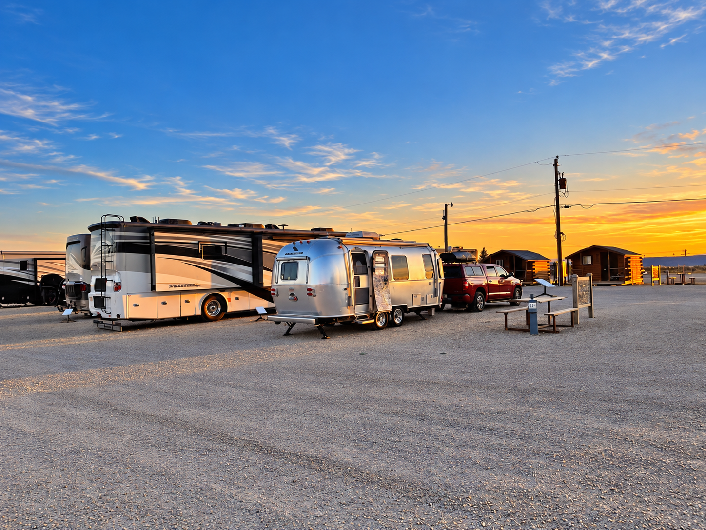 A rv parked in a grassy area with trees in the background