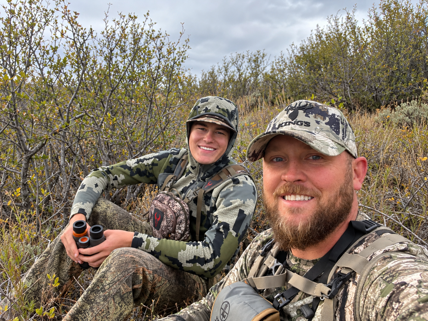 A man holding a shotgun hunting.