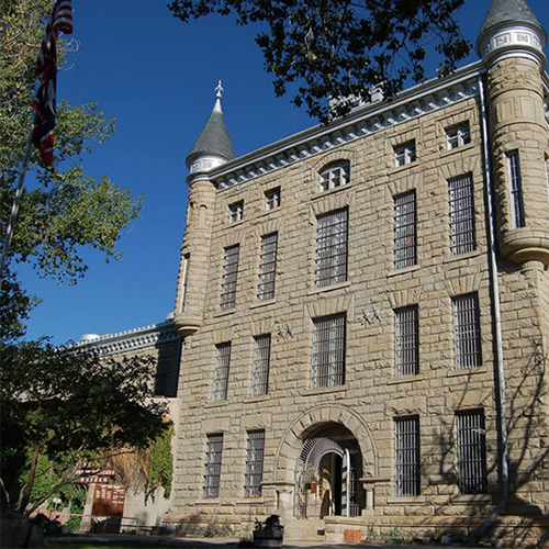 A large brick building with a tower on top of it. Frontier Prison.