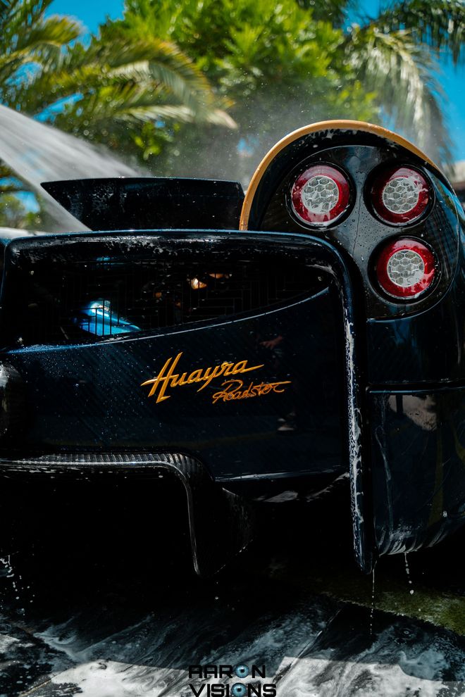 Black Pagani Huayra Roadster being washed; gold script 