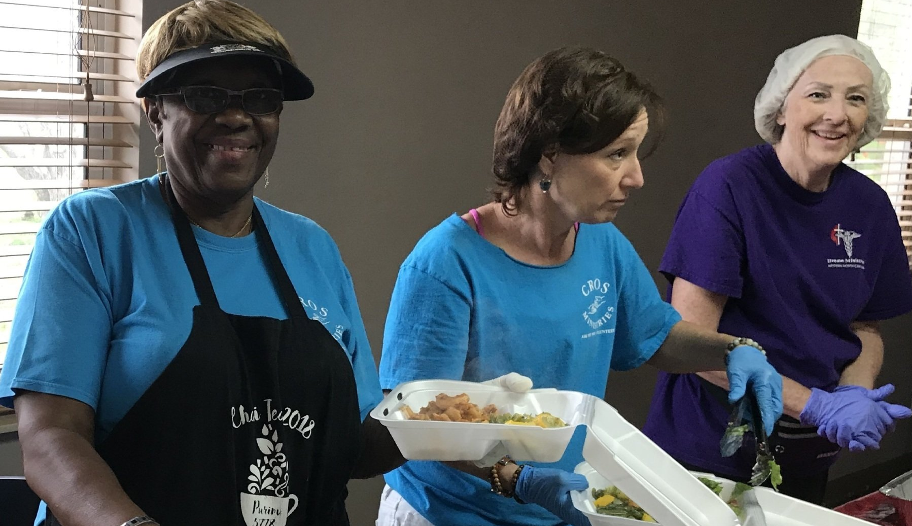 Women serving a meal.