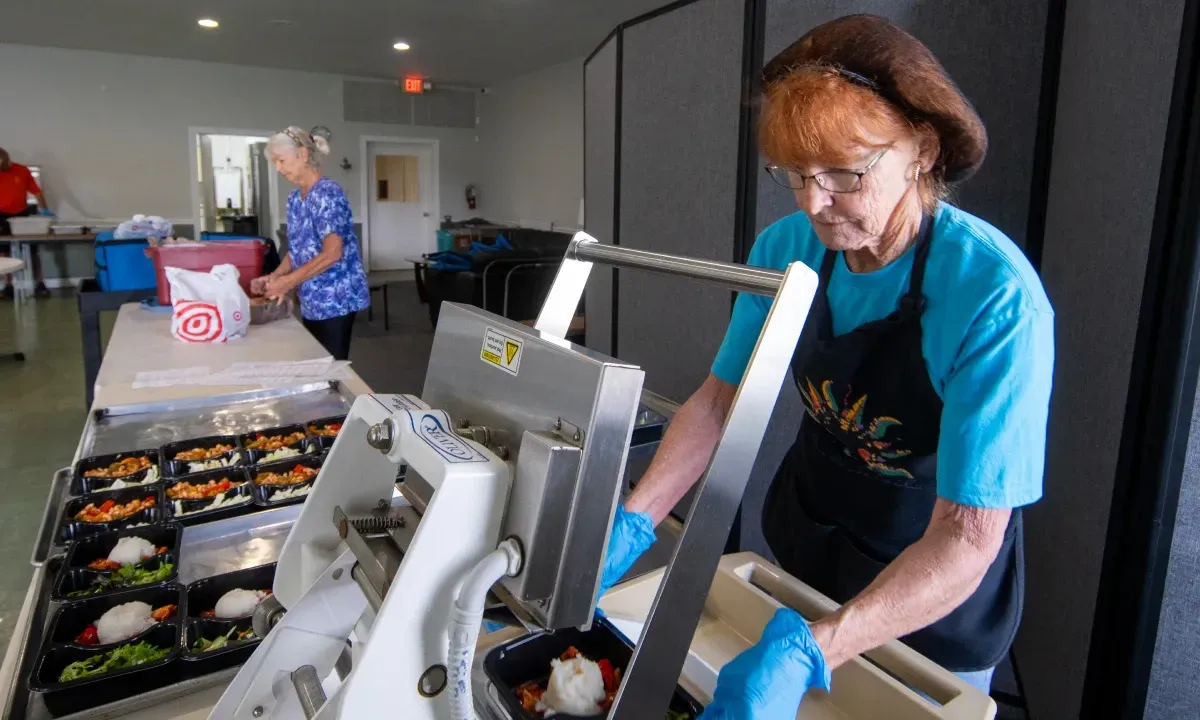 Volunteers preparing mid-day meals.