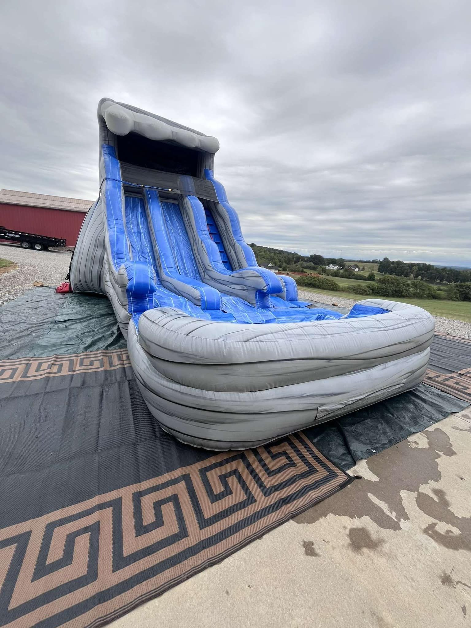A large inflatable water slide is sitting on top of a rug.