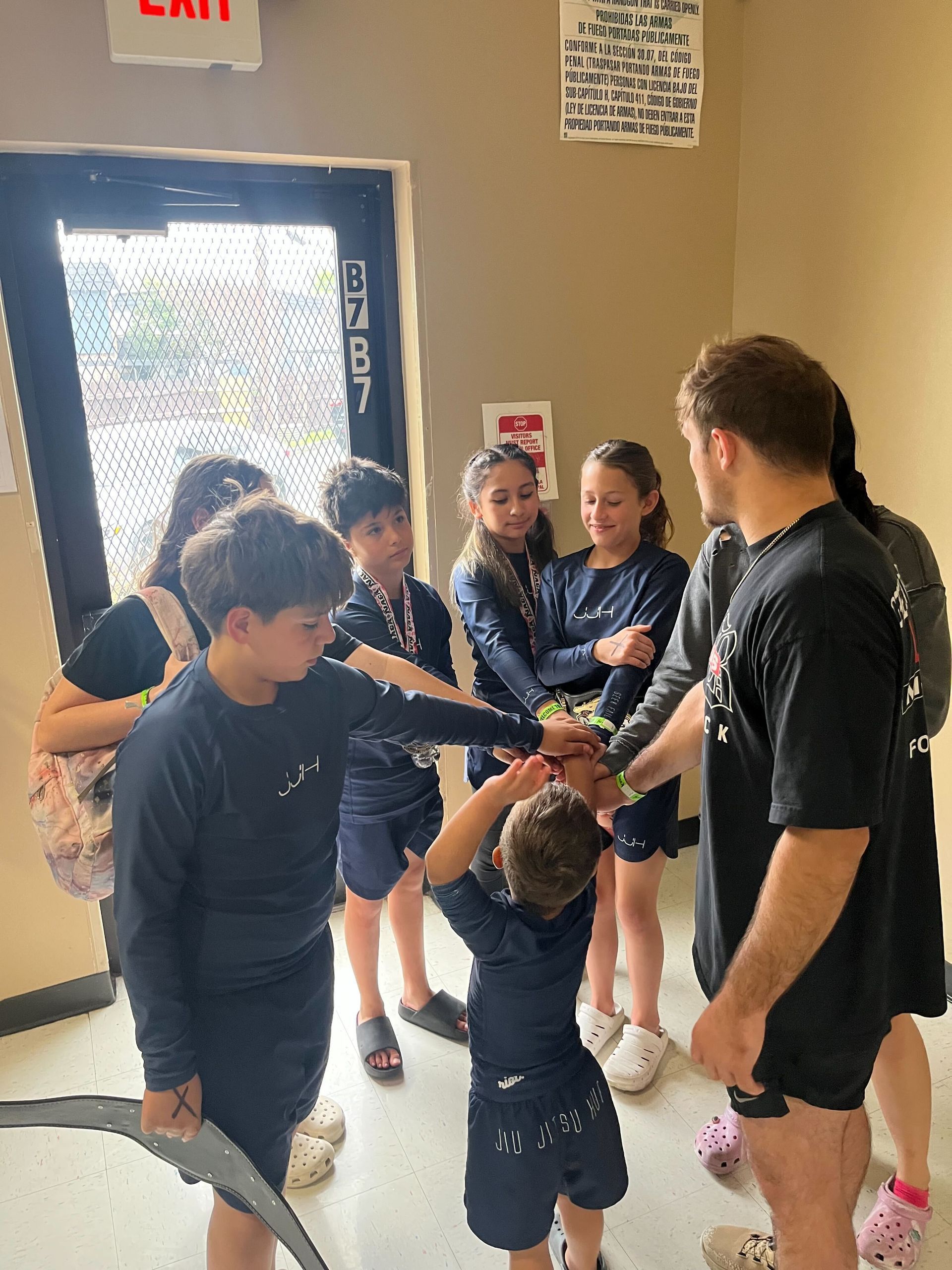 Adults and kids practicing No-Gi grappling at Jiu Jitsu Hub in Georgetown, Texas to build practical self-defense skills.