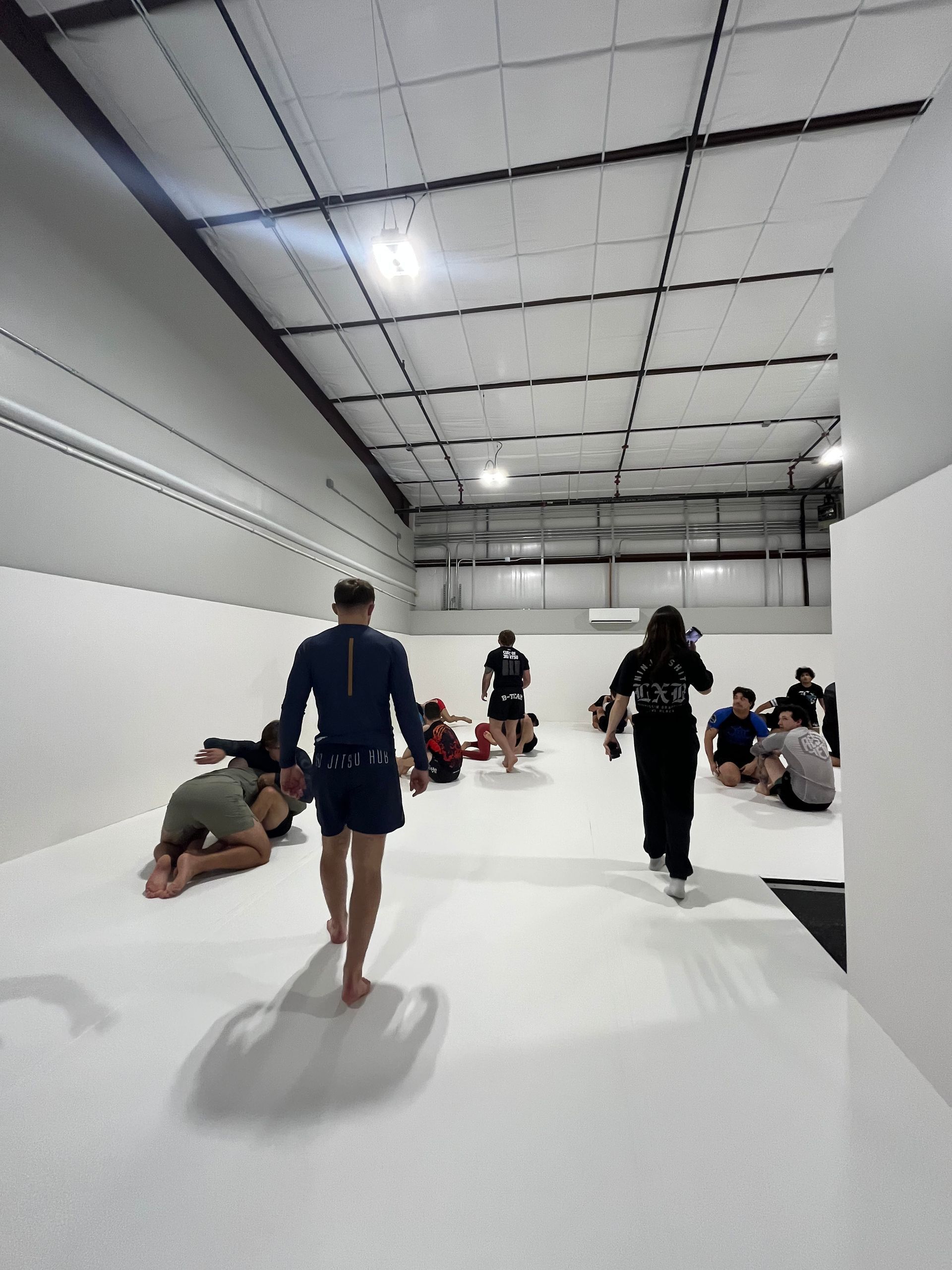 Adults drilling Brazilian Jiu-Jitsu techniques at Jiu-Jitsu Hub in Georgetown, Texas.