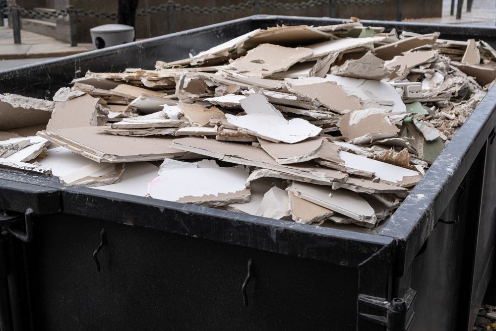 Dumpster filled with broken cardboard and packing debris