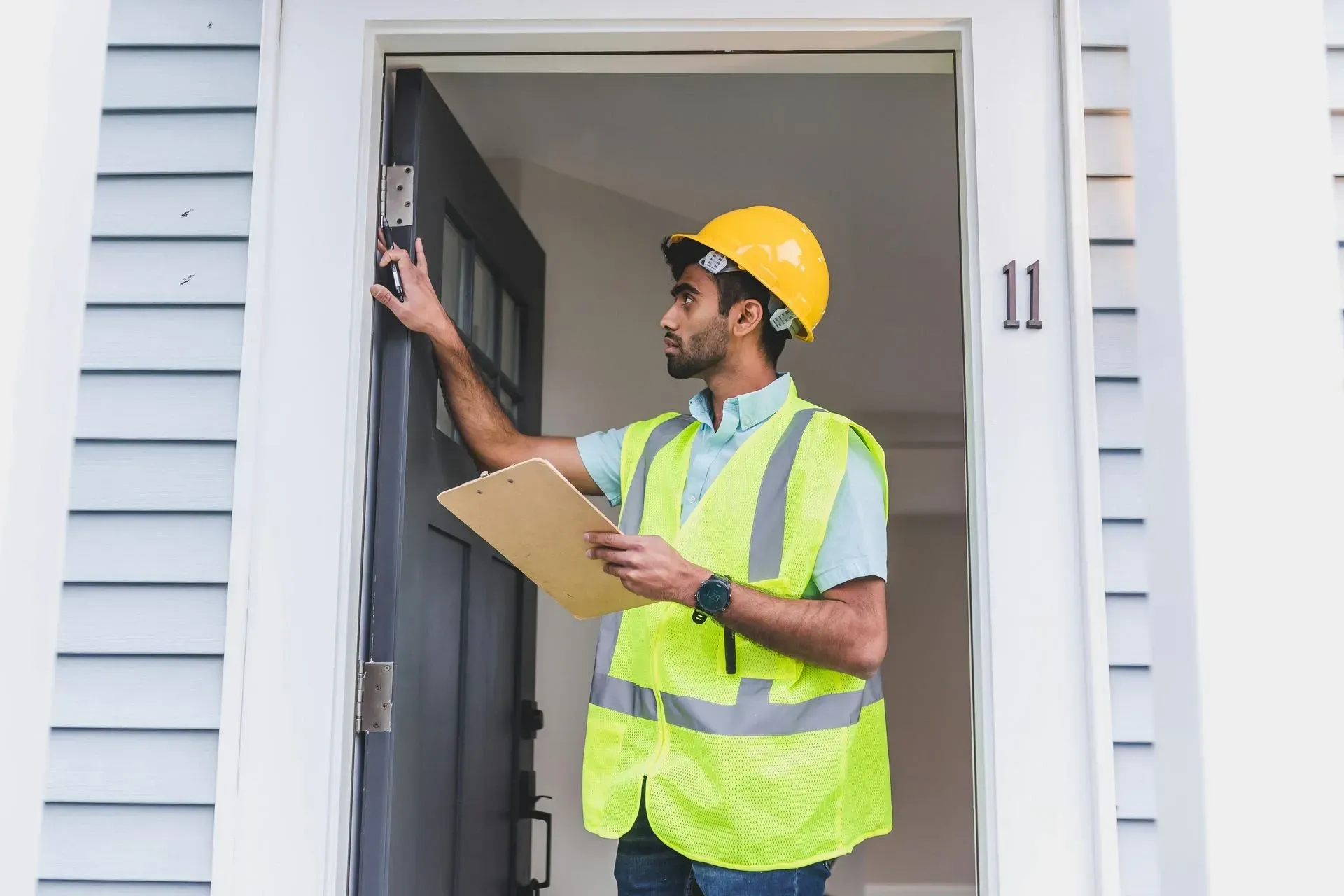 Handyman repairing a front door for a homeowner in Lake County, IL