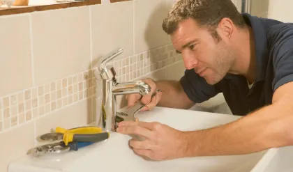 Licensed handyman repairing a kitchen sink leak in Kenosha WI