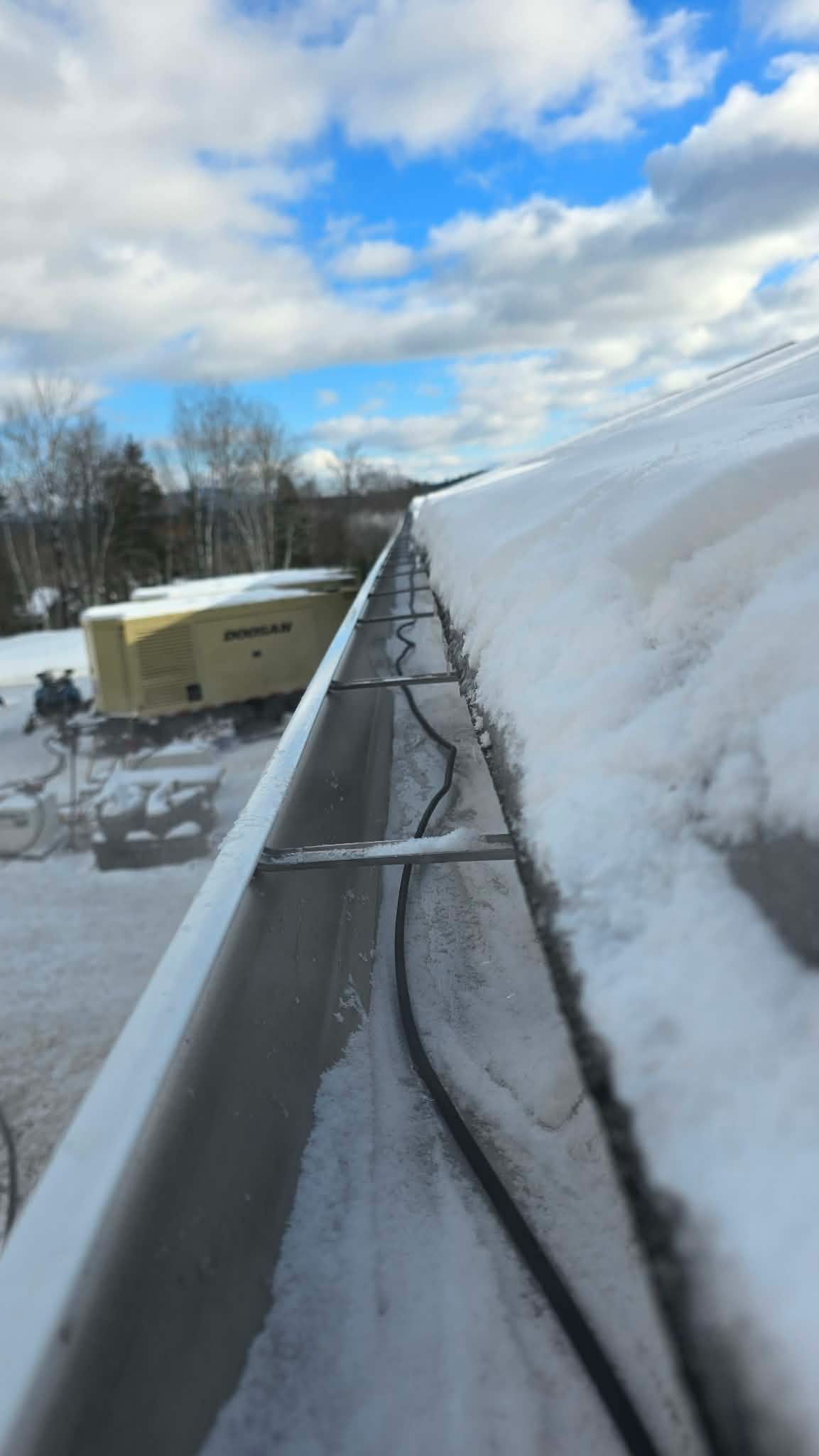A Plymouth, NH installation with 6-inch gutters and heat cables designed for a property dealing with winter snow and ice.