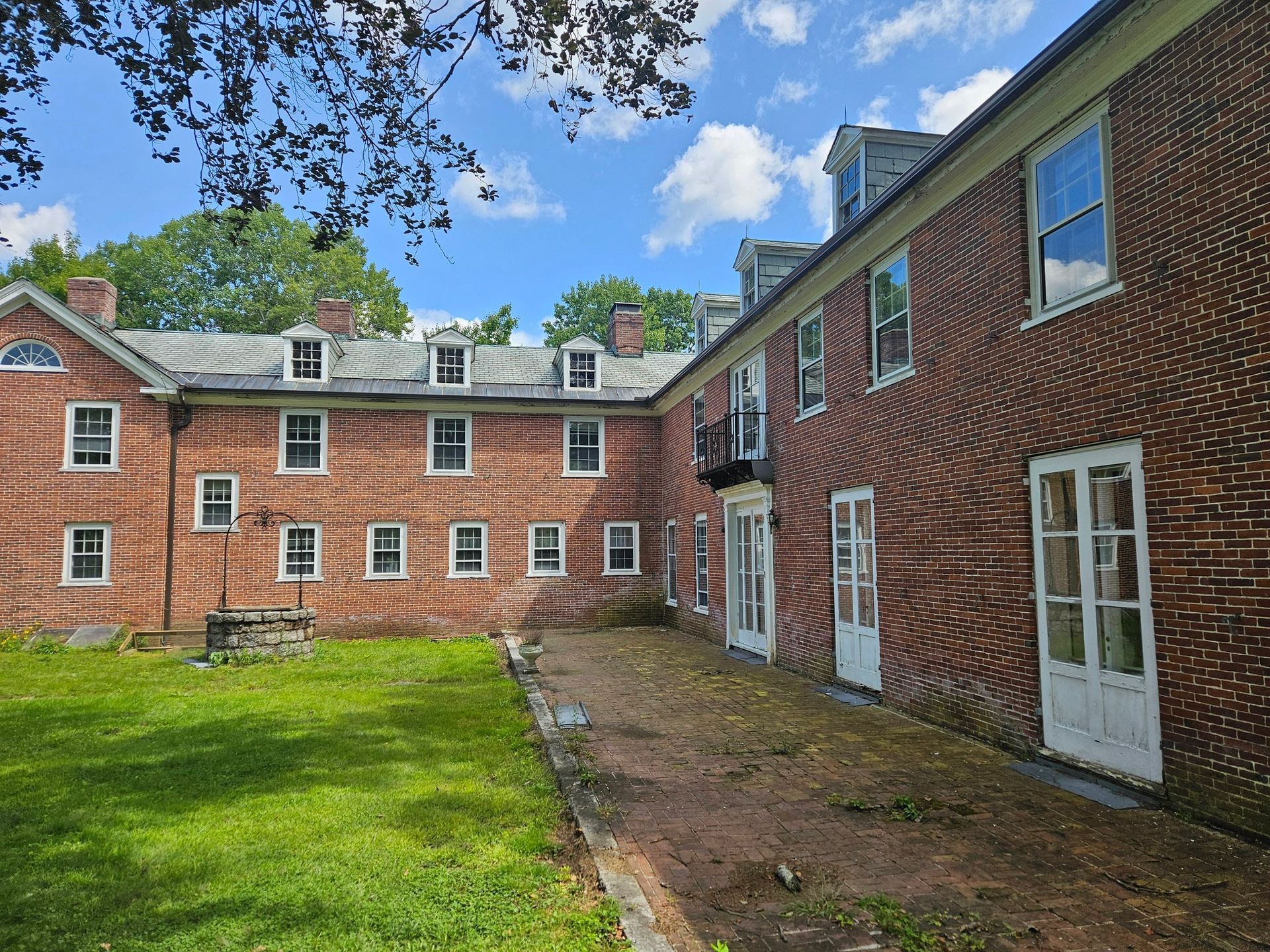 A large brick building with a lot of windows and doors
