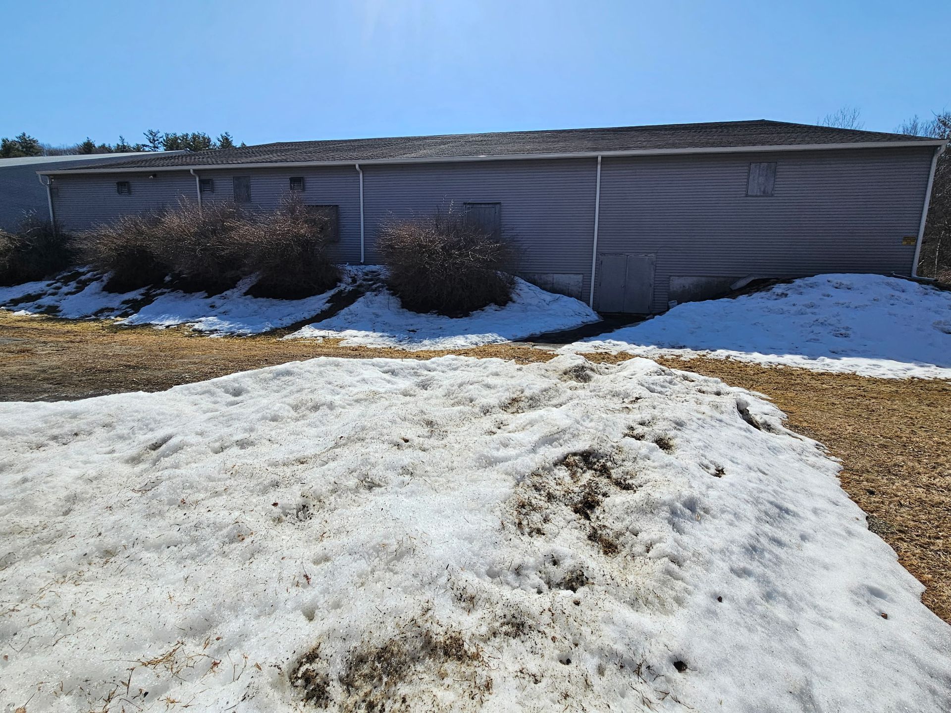 Multiple Downspouts were needed to handle the runoff from heavy rain on this large flat roof