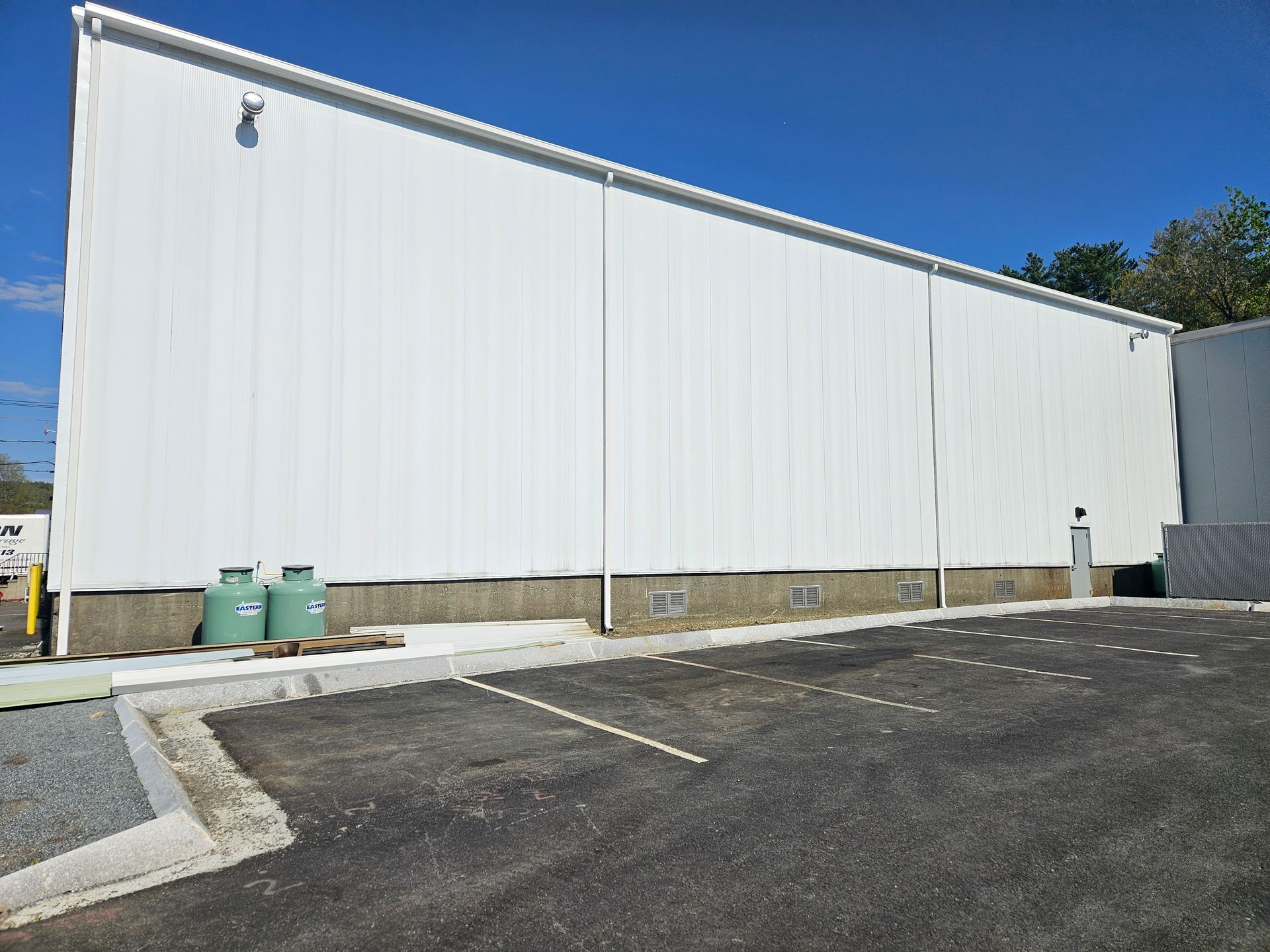 Large-scale aluminum gutter system installed on commercial property in NH