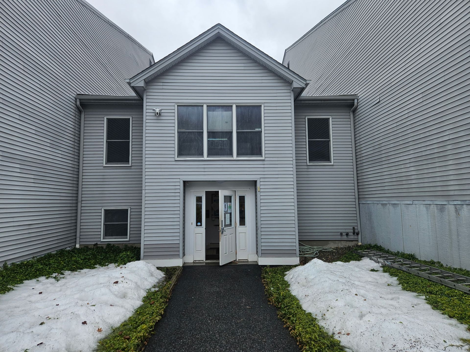 Monadnock Tennis Club commercial building in Peterborough New Hampshire with new gutter system installed by New England Gutter Systems to improve walkway drainage