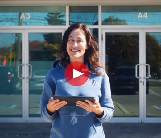 Woman in blue sweater holding a tablet outside glass doors with text: “CLEAN SPACES ARE COSTING THEM”