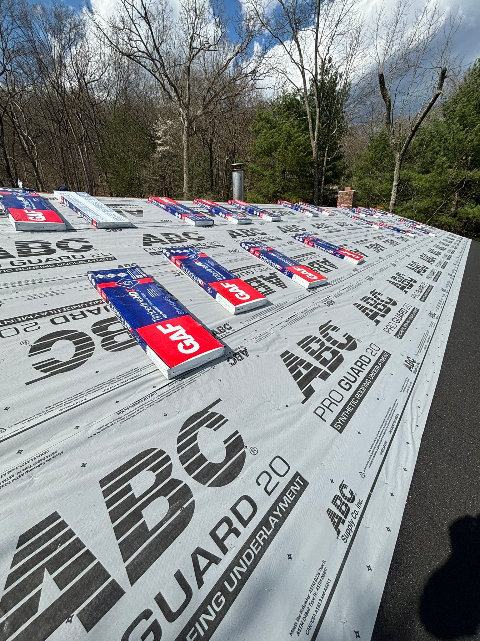 Roof with ABC Guard 20 underlayment and red/blue shingle tabs.
