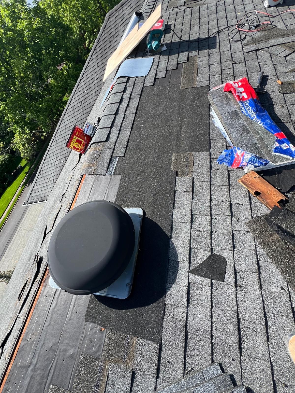 Roof partially torn off, new vent installed, tools and debris visible.