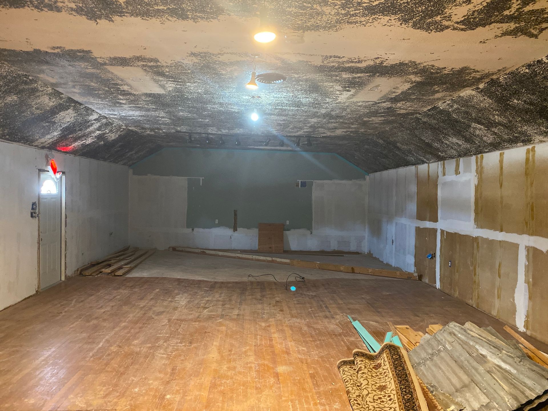 Empty basement or cellar with a low, arched ceiling and unfinished walls and floor