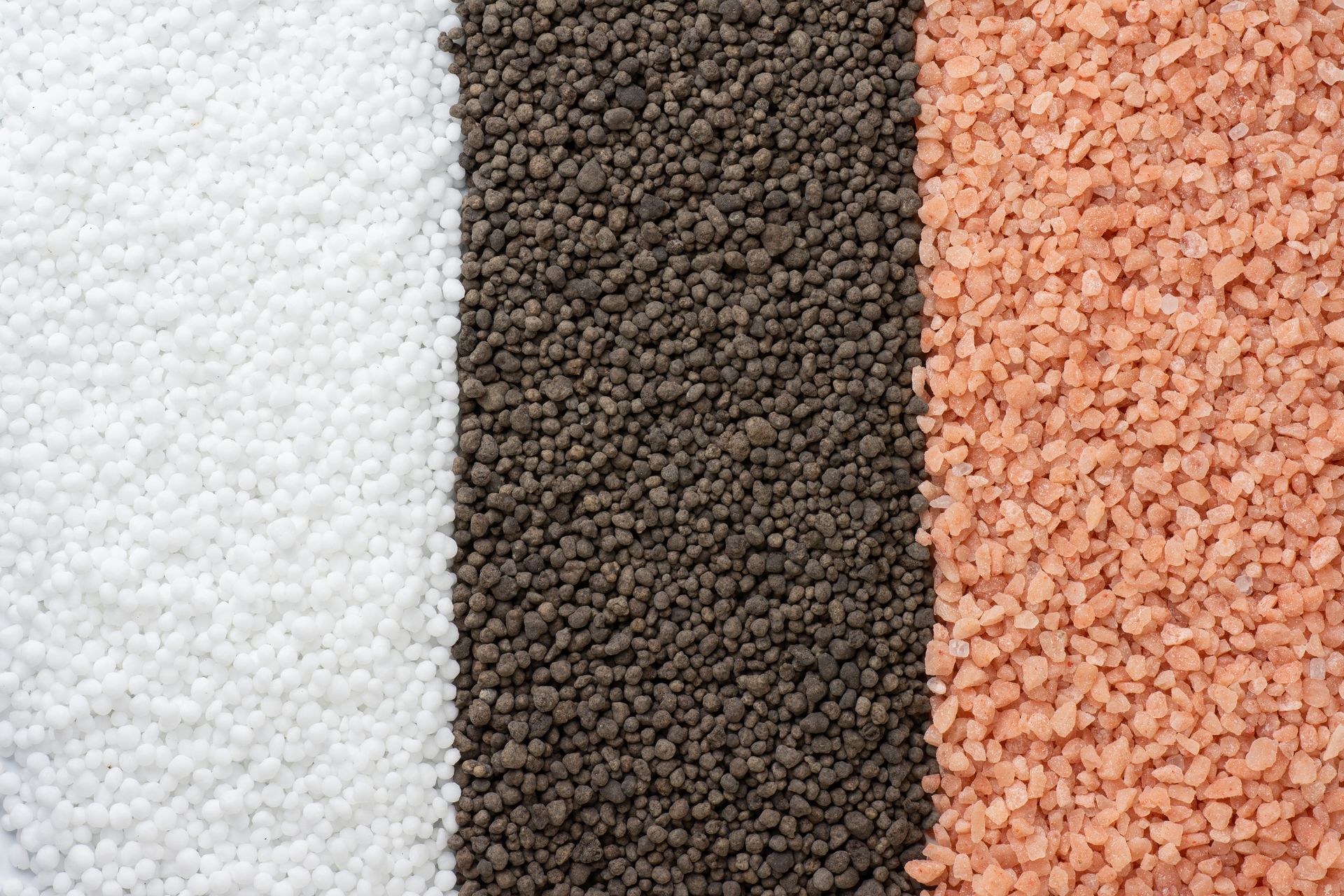 Three vertical piles of granules: white, dark brown, and pinkish orange.