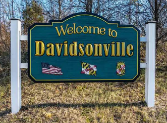 Welcome to Davidsonville sign with green background and small Maryland and U.S. flags