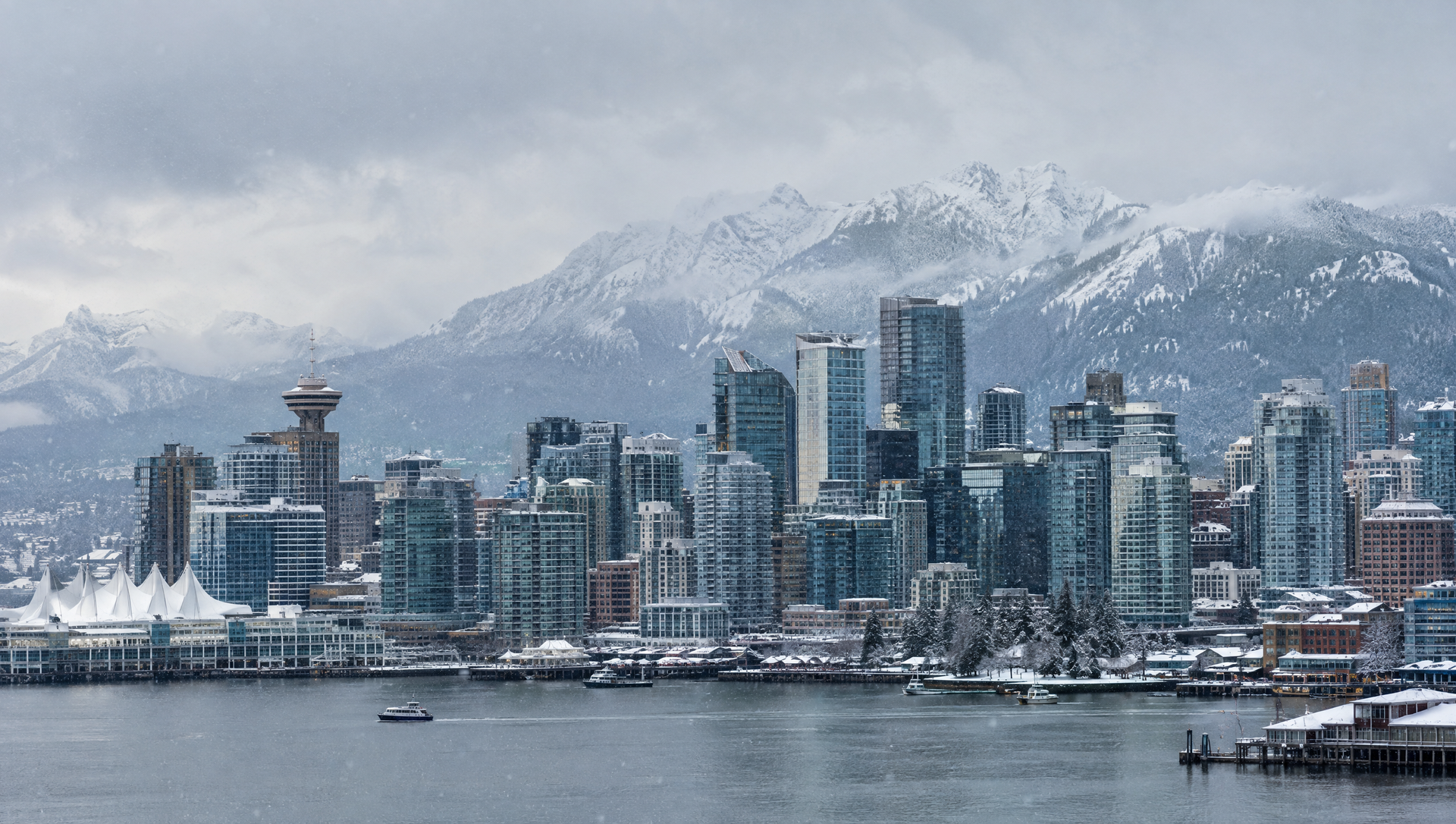 Downtown Vancouver skyline in winter snow with the North Shore mountains