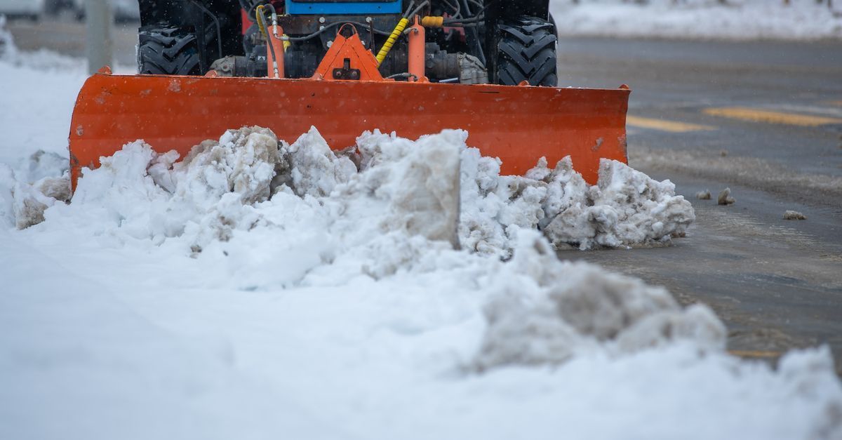 Signed commercial snow removal contract on a desk with a pen