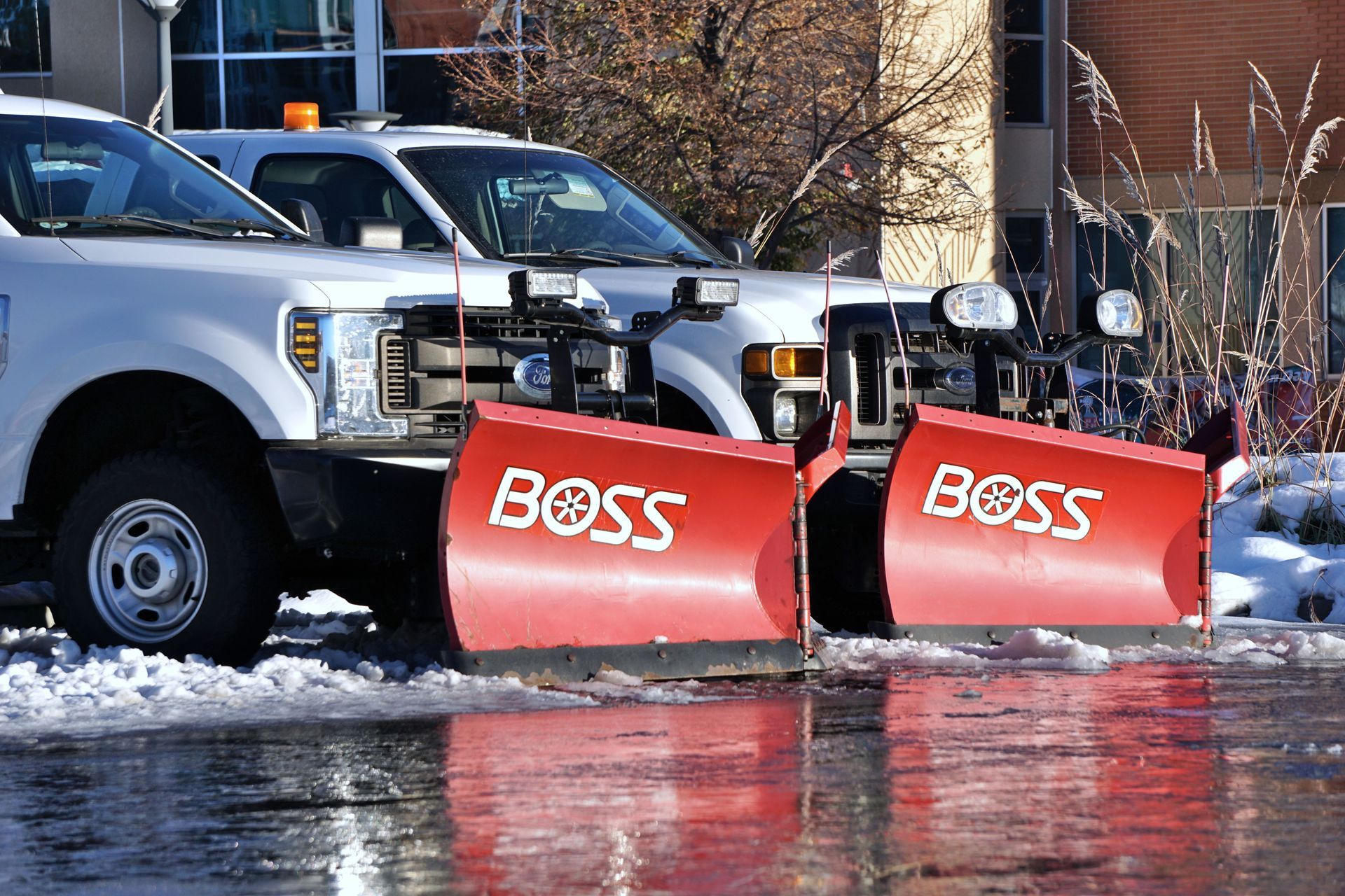 Commercial snow plow clearing a multi-property parking lot in the Pacific Northwest