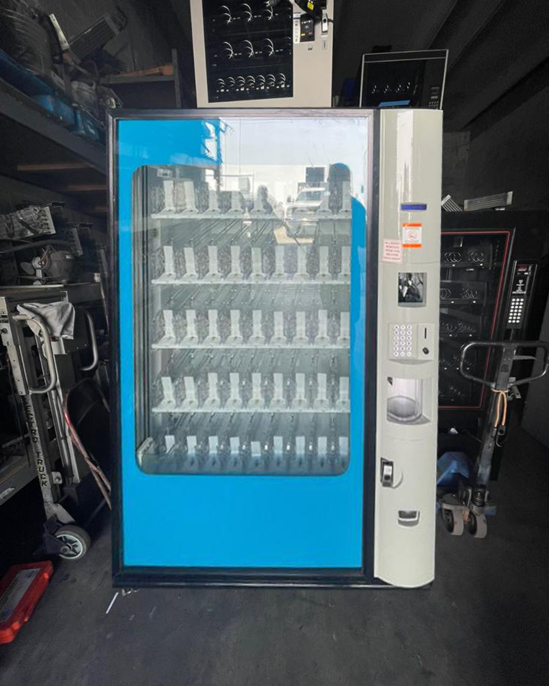 A blue and white vending machine with a glass door