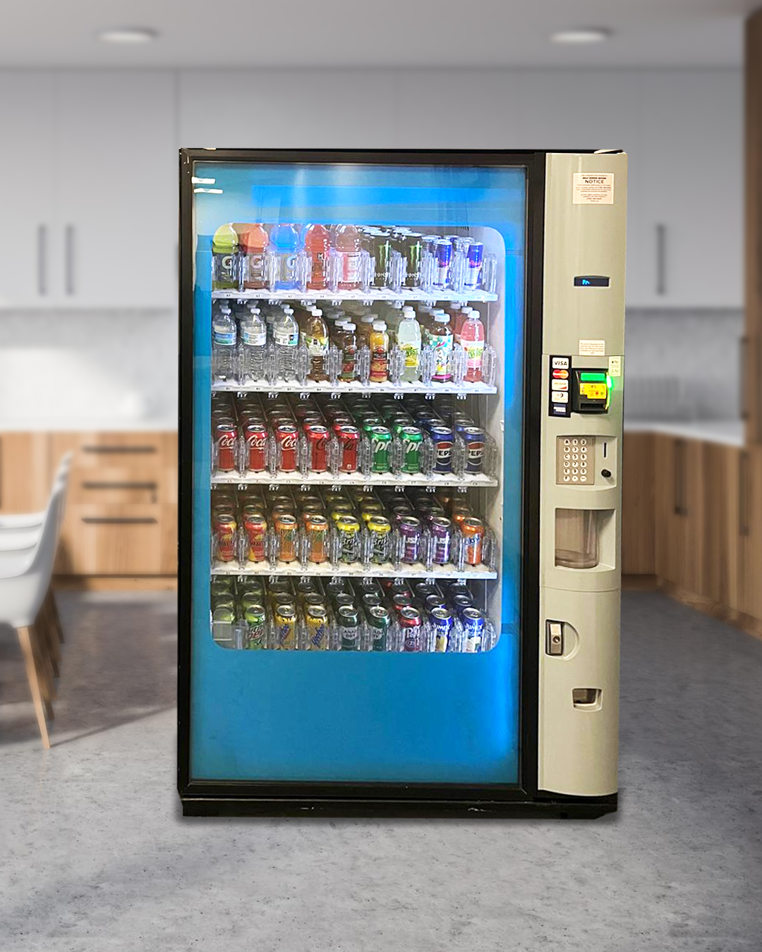 A vending machine filled with lots of drinks in a kitchen.