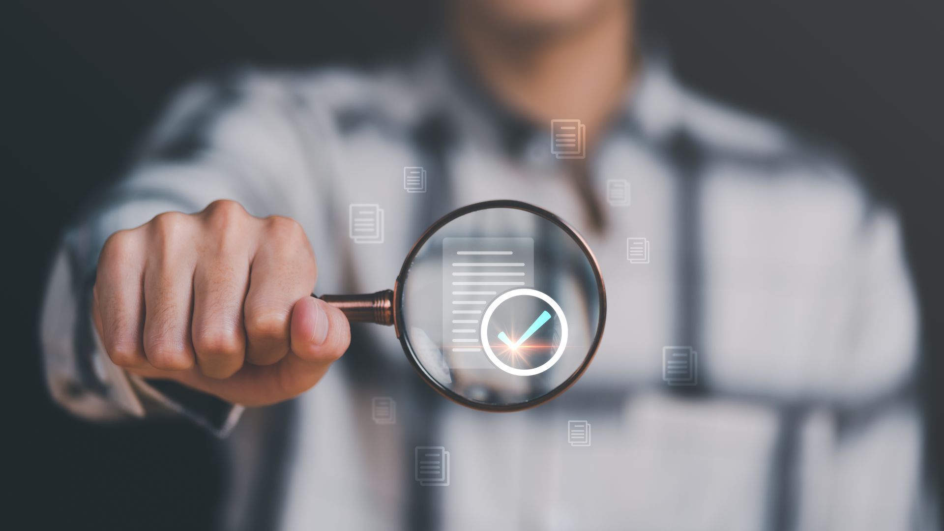 Man Holding A Magnifier