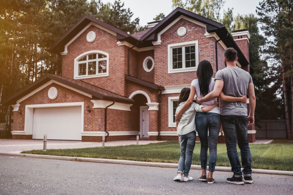 family standing outside home with new garage door