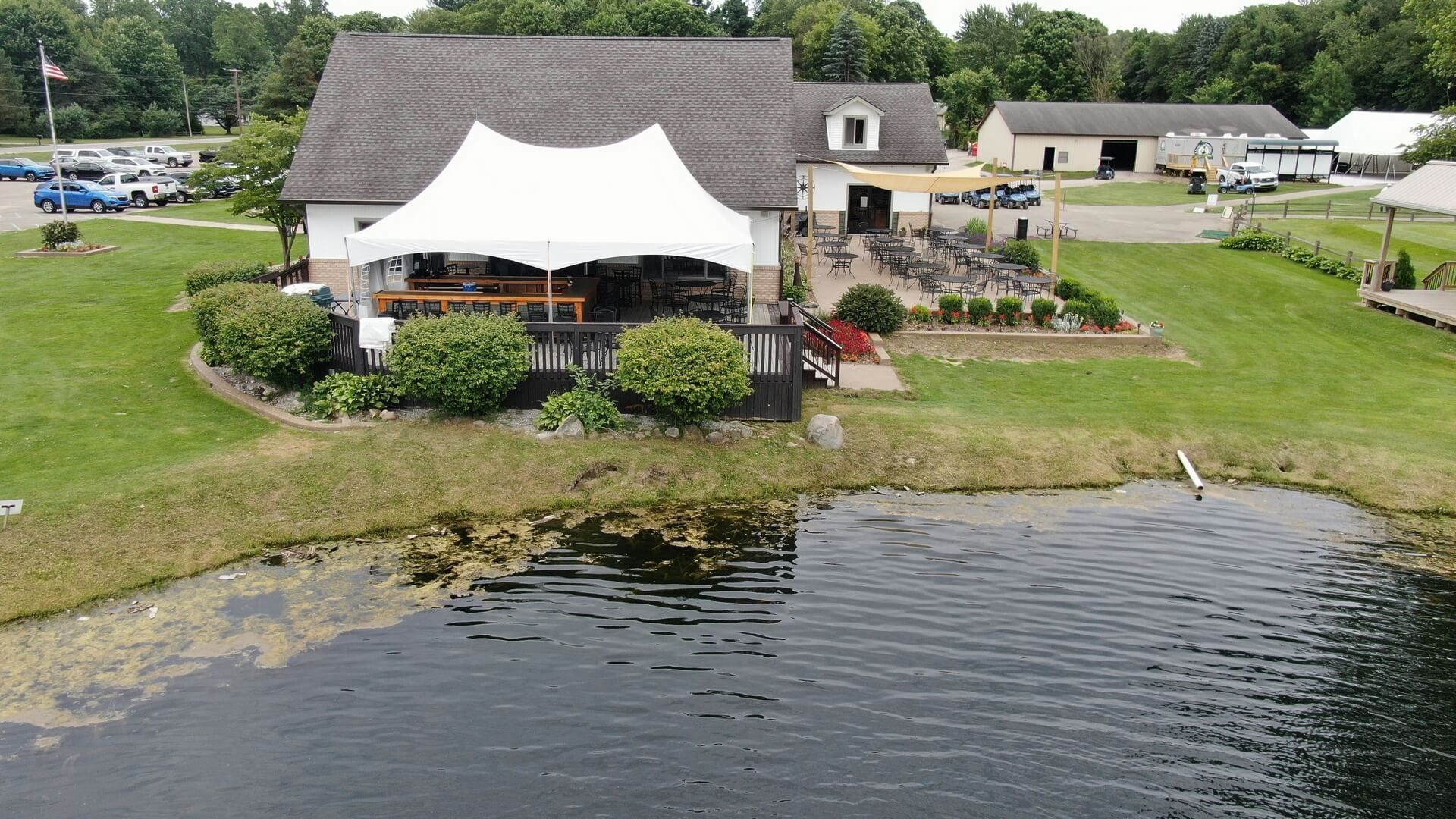 An aerial view of Little Camille's by the Green restaurant with a pond in front of it in Casco, Michigan.