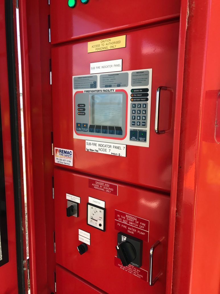 A red electrical box with a monitor and buttons on it