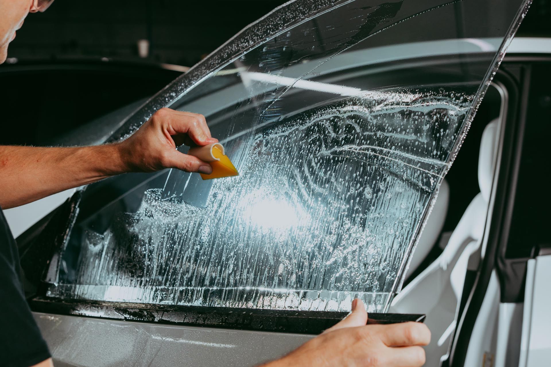 A close up of a car window with a sticker on it.