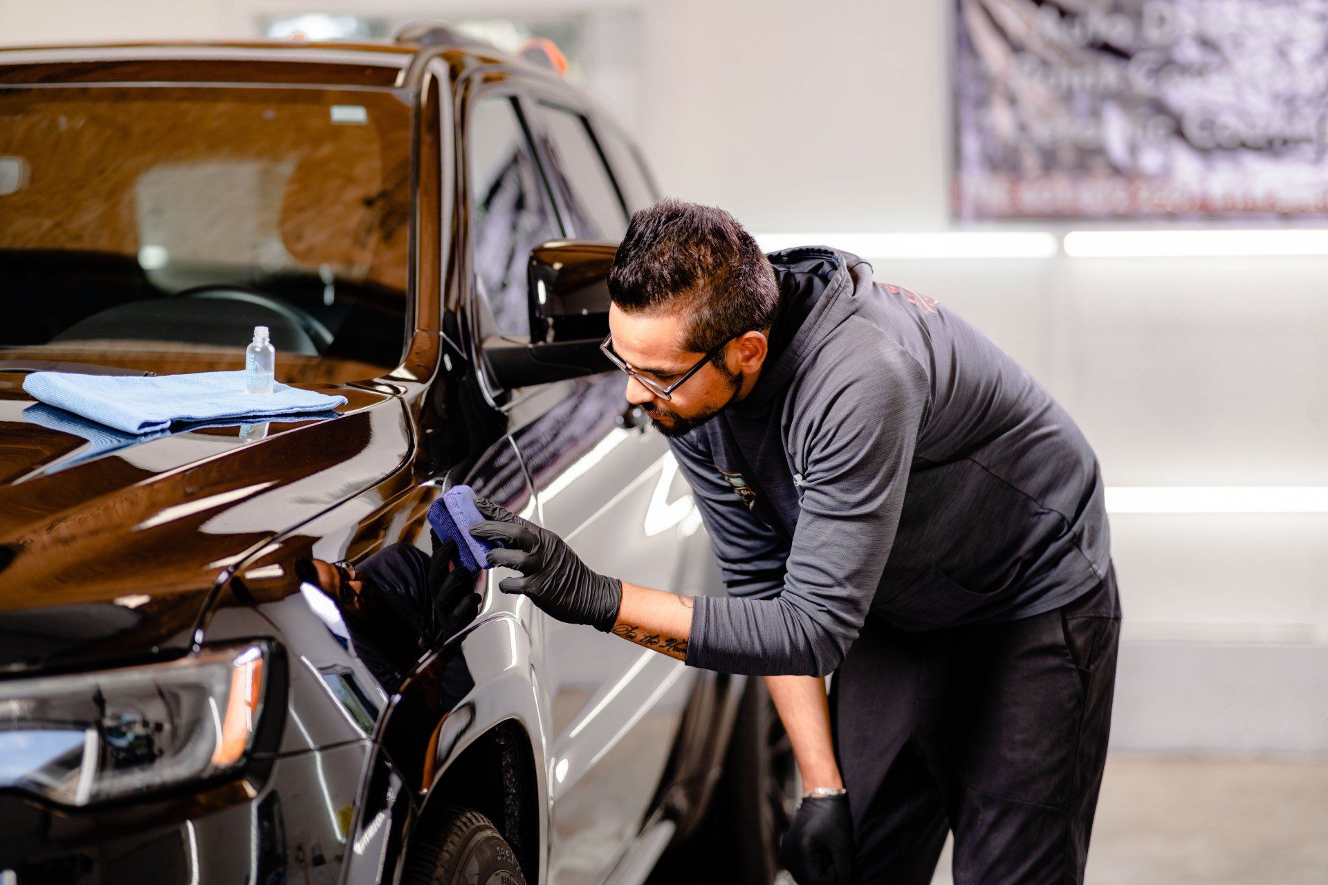 a man is polishing a car in a garage .