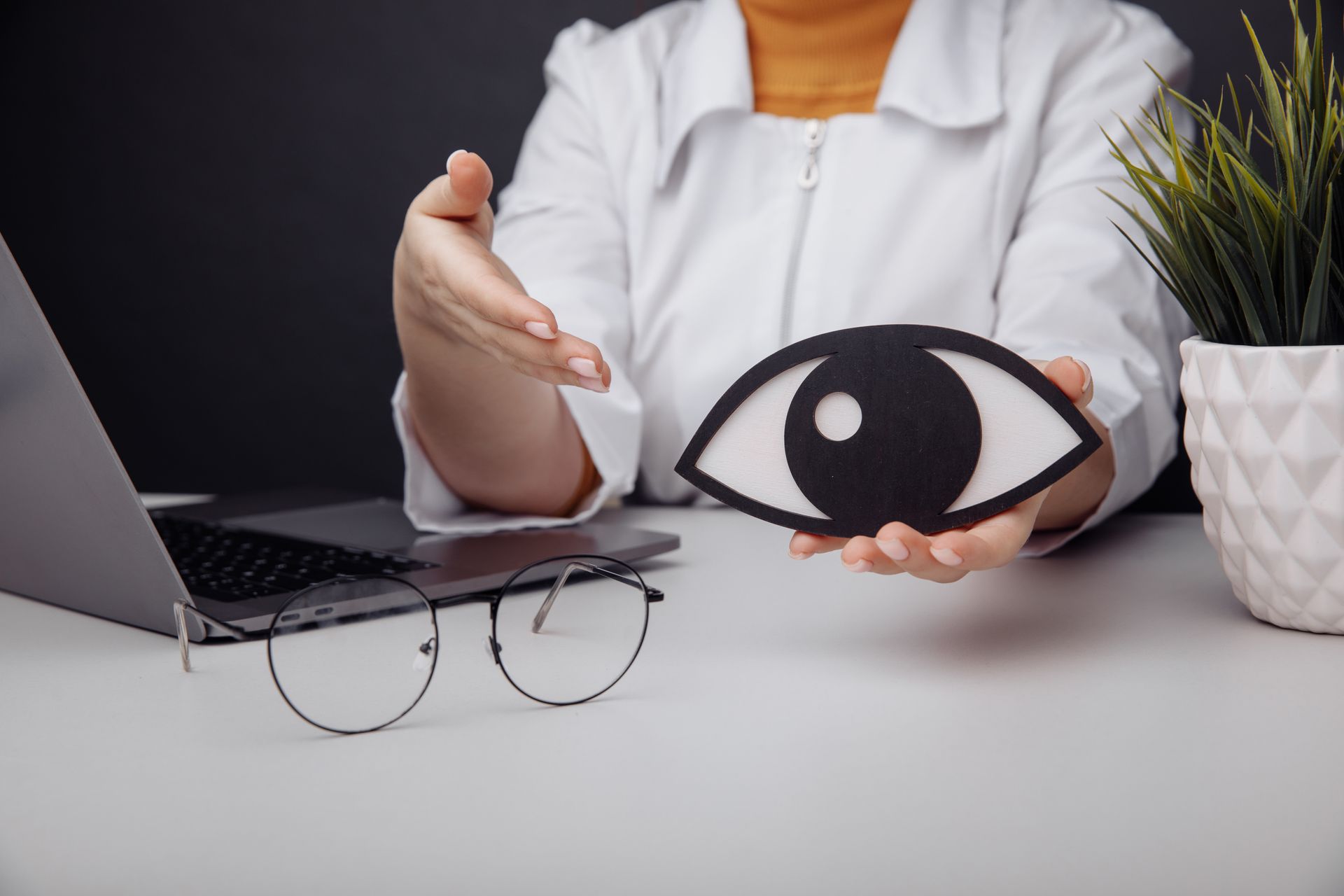 Wooden eye in doctor's hand. Early diagnosis and care concept