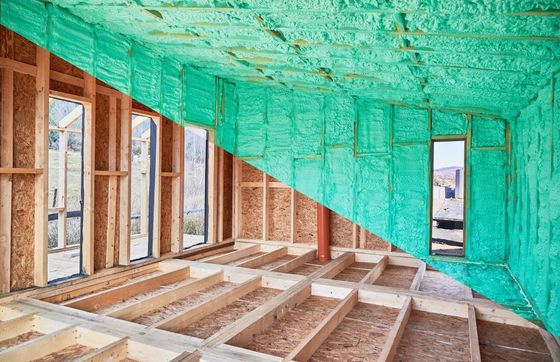 Partially built room with exposed wooden framing and turquoise insulation on the walls and ceiling