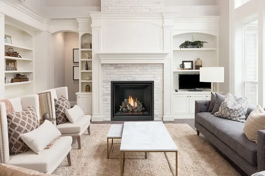A living room filled with furniture and a fireplace.