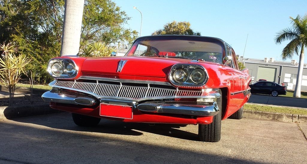 A red car is parked on the side of the road — Pialba Brake Clutch & Steering Centre in Pialba, QLD