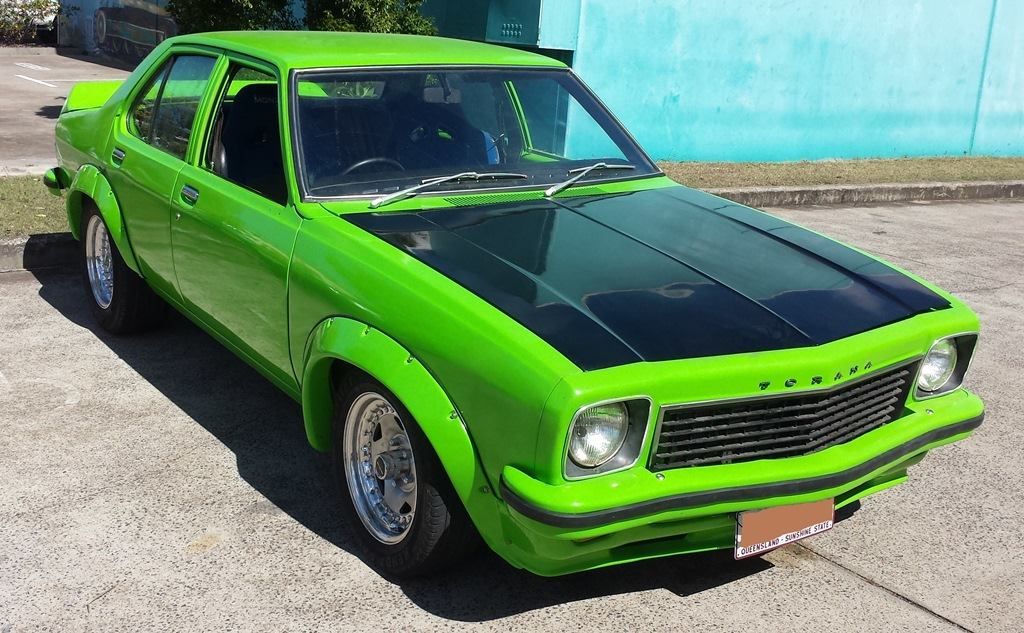 Bright green classic car with black hood parked on pavement — Pialba Brake Clutch & Steering Centre in Pialba, QLD