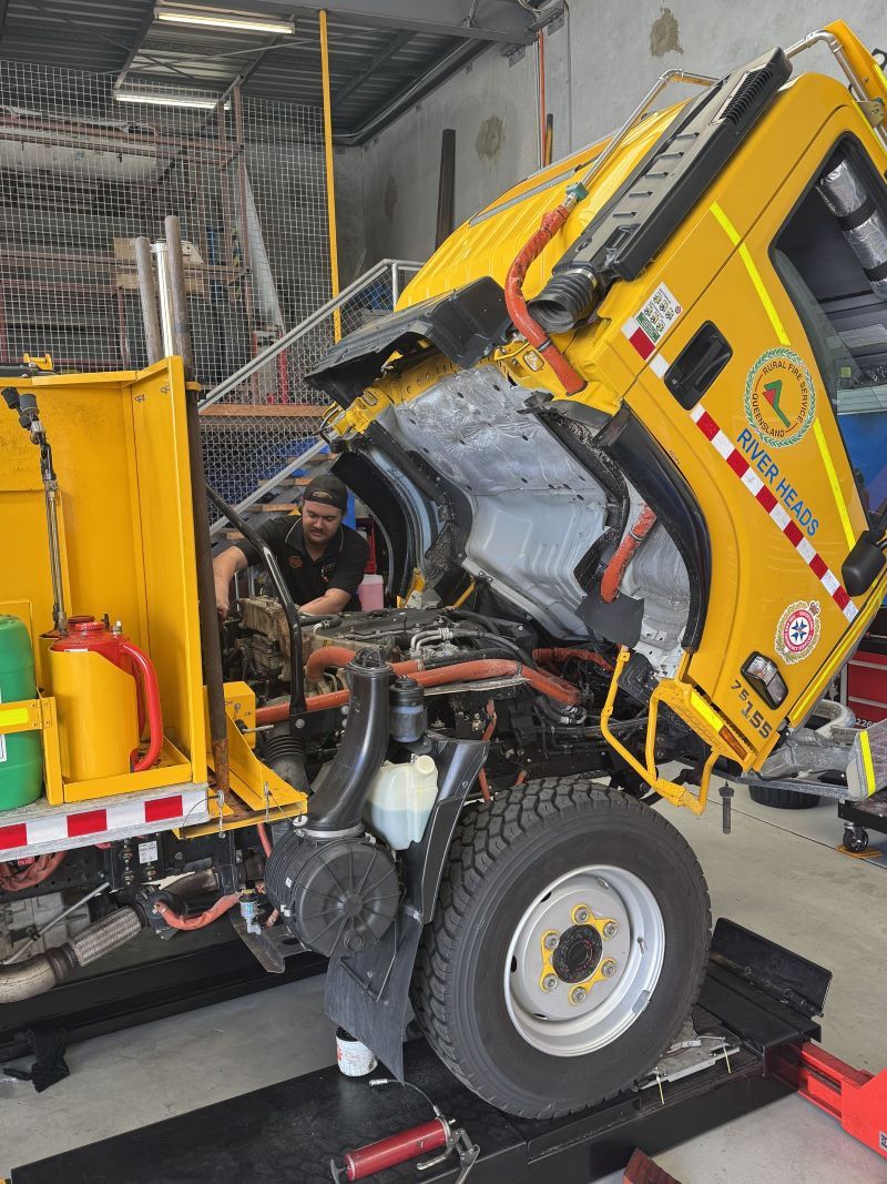A Man Is Working on The Engine of A Truck — Pialba Brake Clutch & Steering Centre in Pialba, QLD