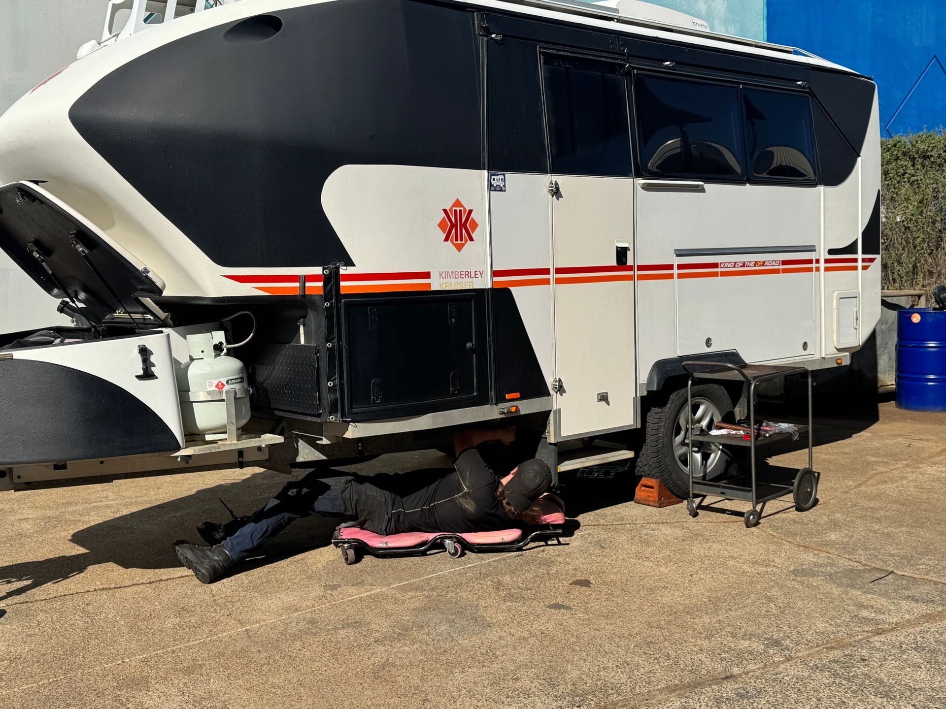A White Caravan is Parked in a Gravel Lot — Pialba Brake Clutch & Steering Centre in Pialba, QLD