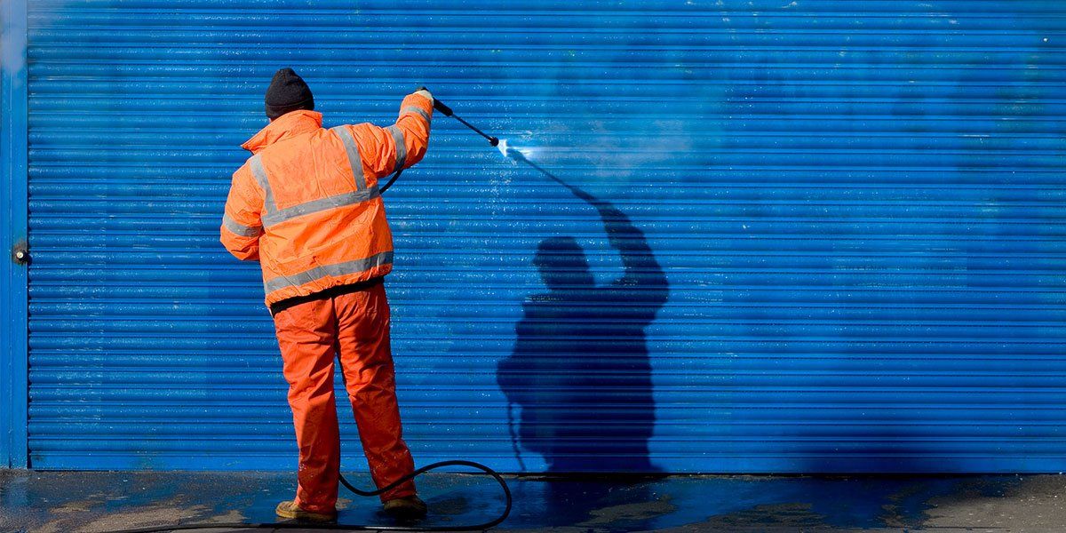 Cleaning Graffiti Off a Security Grill — Newcastle, NSW — HCS Hunter Cleaning Service Cleaning Graffiti Off a Security Grill — Newcastle, NSW — HCS Hunter Cleaning Service