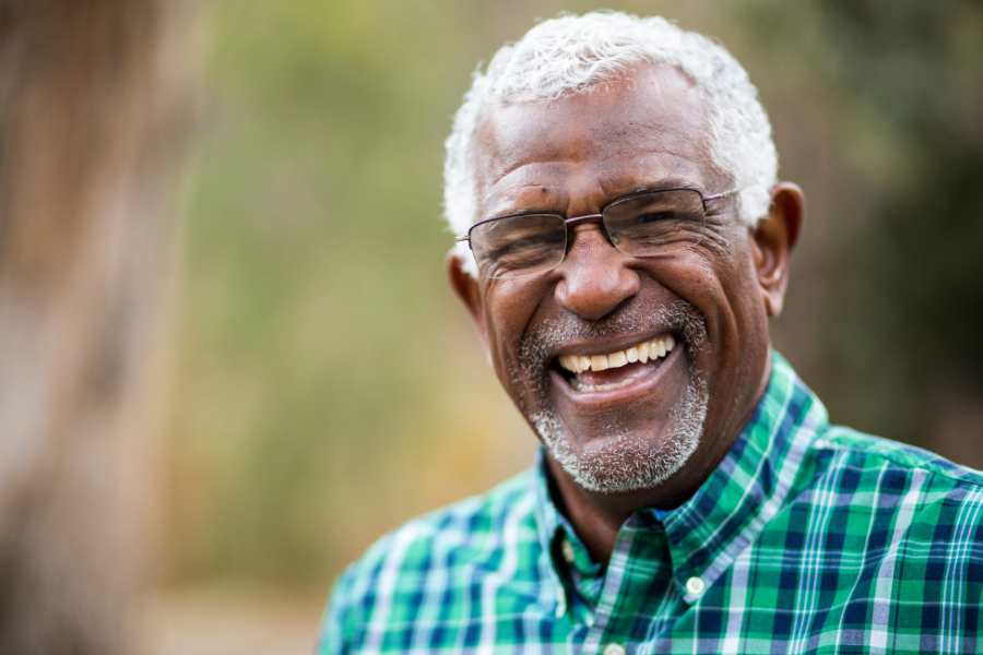 Photo of man in glasses smiling.