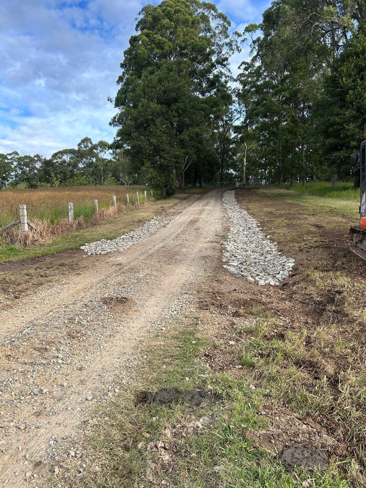 Gravel Driveway With Rock Borders Leading Towards Trees — MG Earthworks and Plant Hire in Port Macquarie, NSW