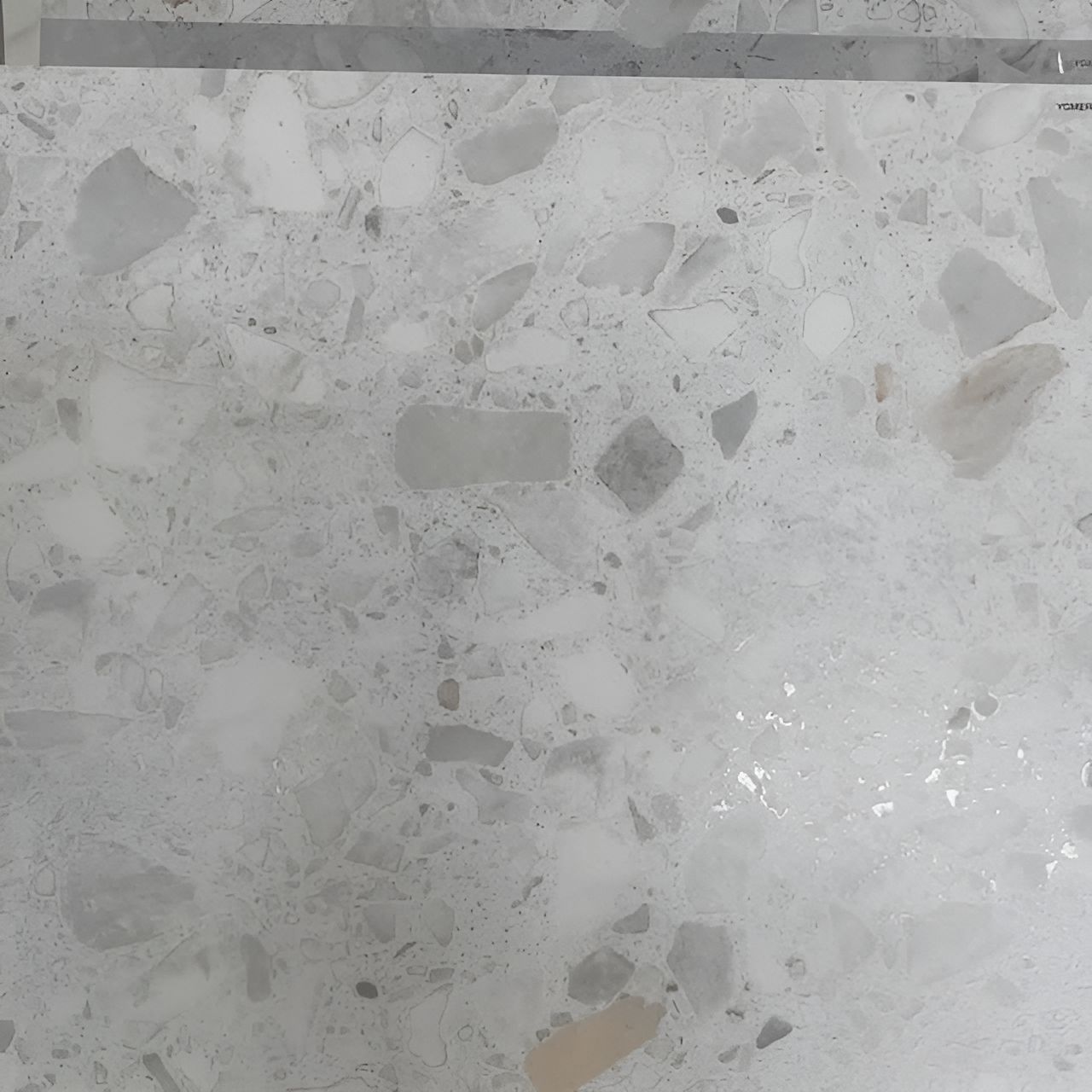 A Close Up Of A White Marble Counter Top With A Gray Border — Tile Centre NT In Winnellie, NT
