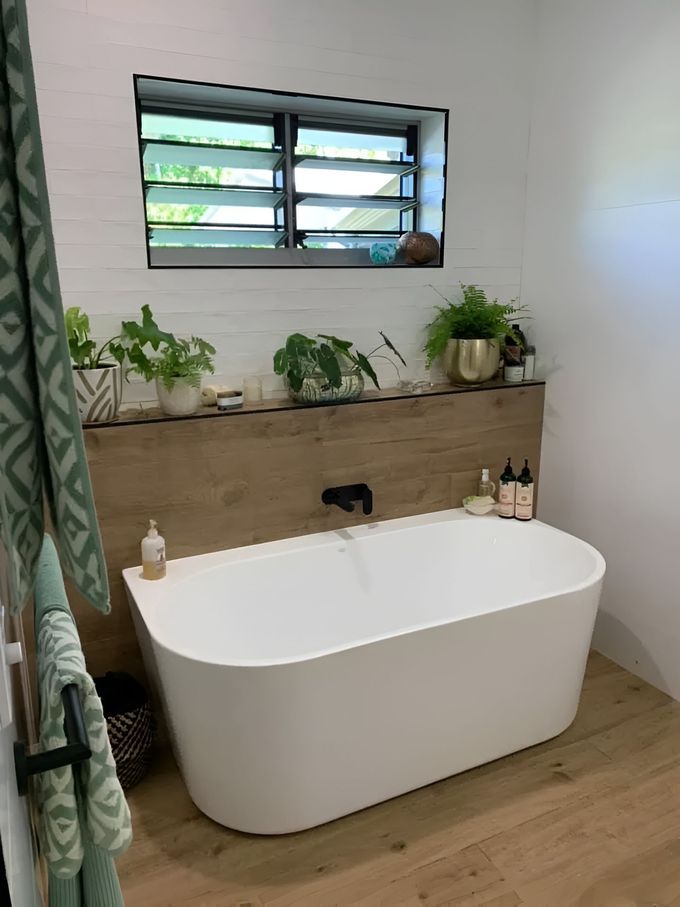 A Bathroom With A Bathtub And A Window — Tile Centre NT In Winnellie, NT