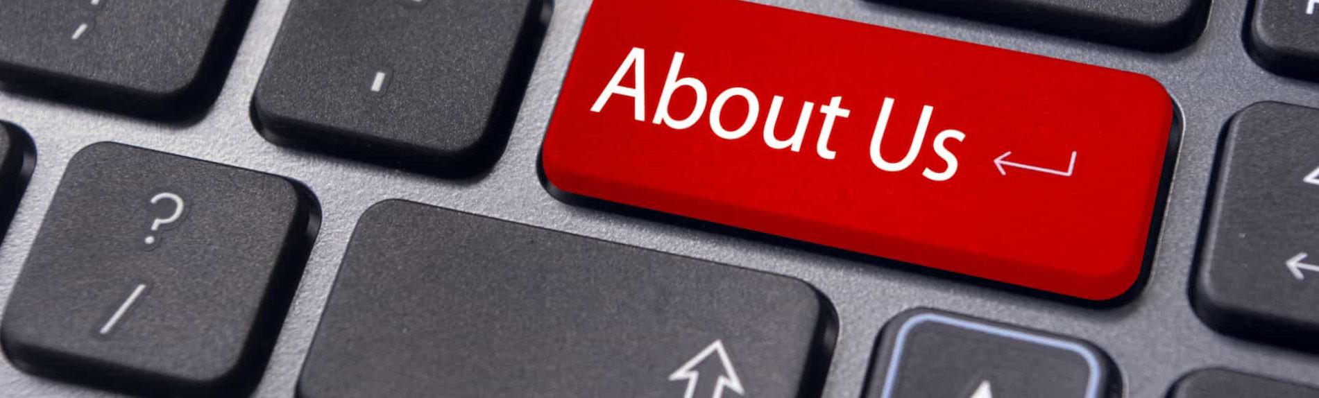 A close up of a keyboard with a red about us button
